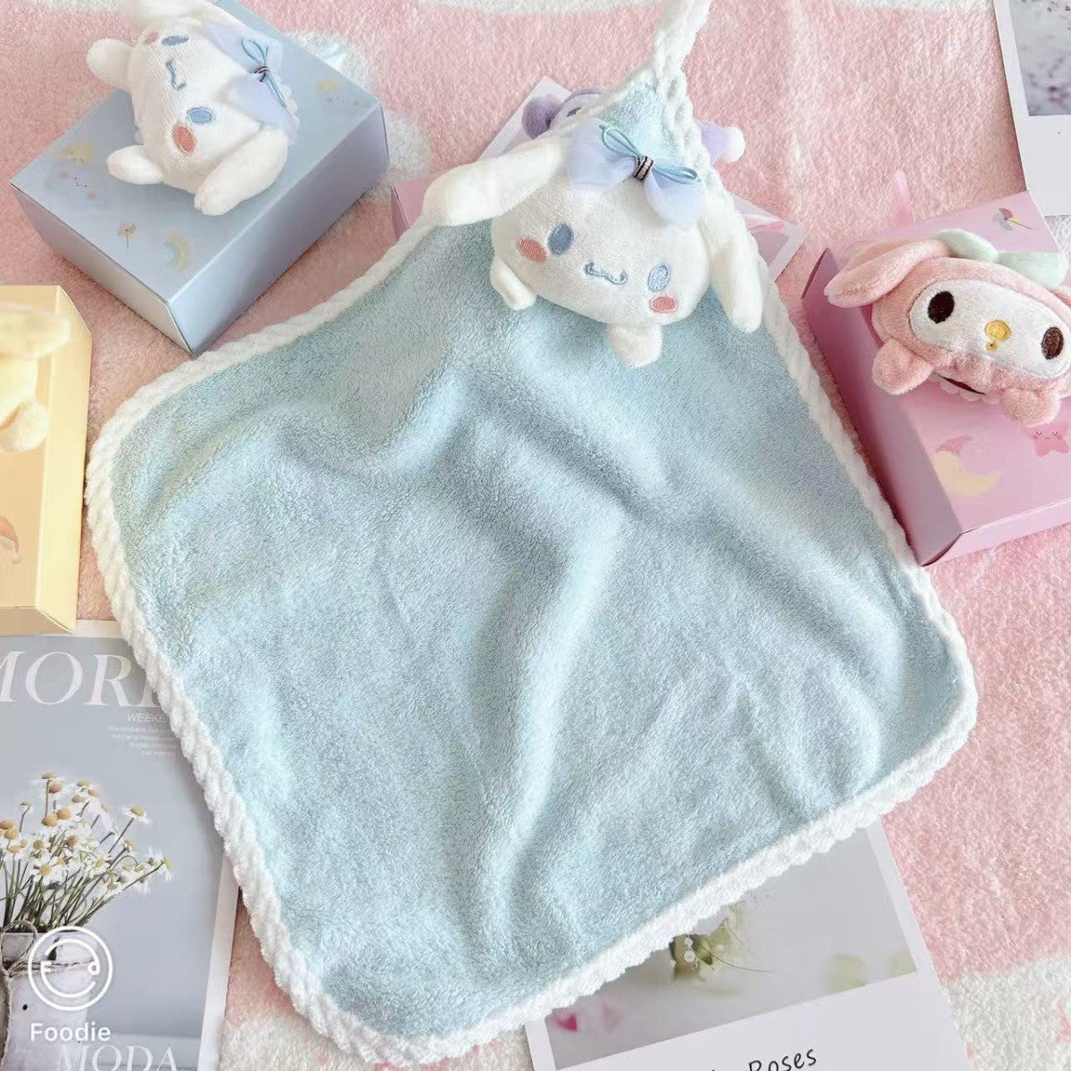 Unfolded light blue square coral fleece hand towel with Cinnamoroll plush face and hanging loop